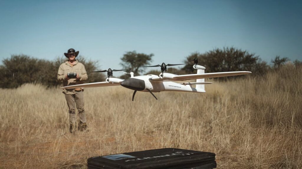 Trinity F90+ fixed-wing drone with vertical takeoff rotors and aerodynamic body on white background.